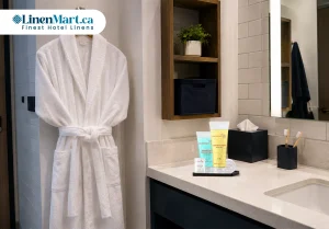 Bathrobe with soap, shampoo and conditioner arranged in a student residence bathroom